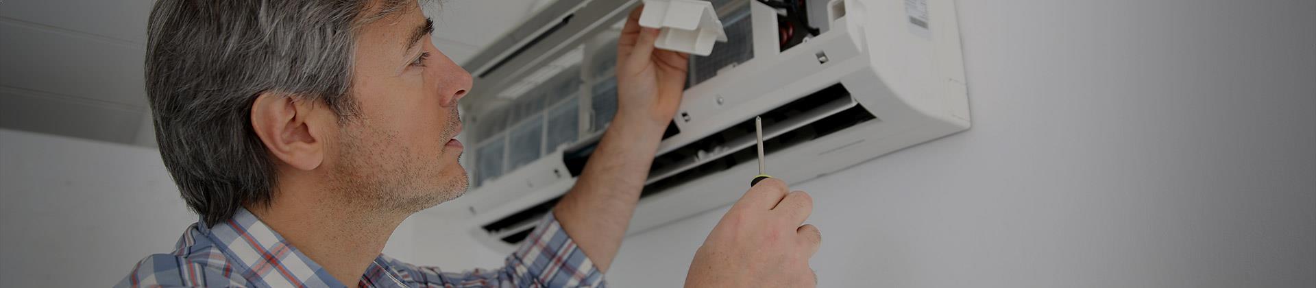 Man cleaning heat pump